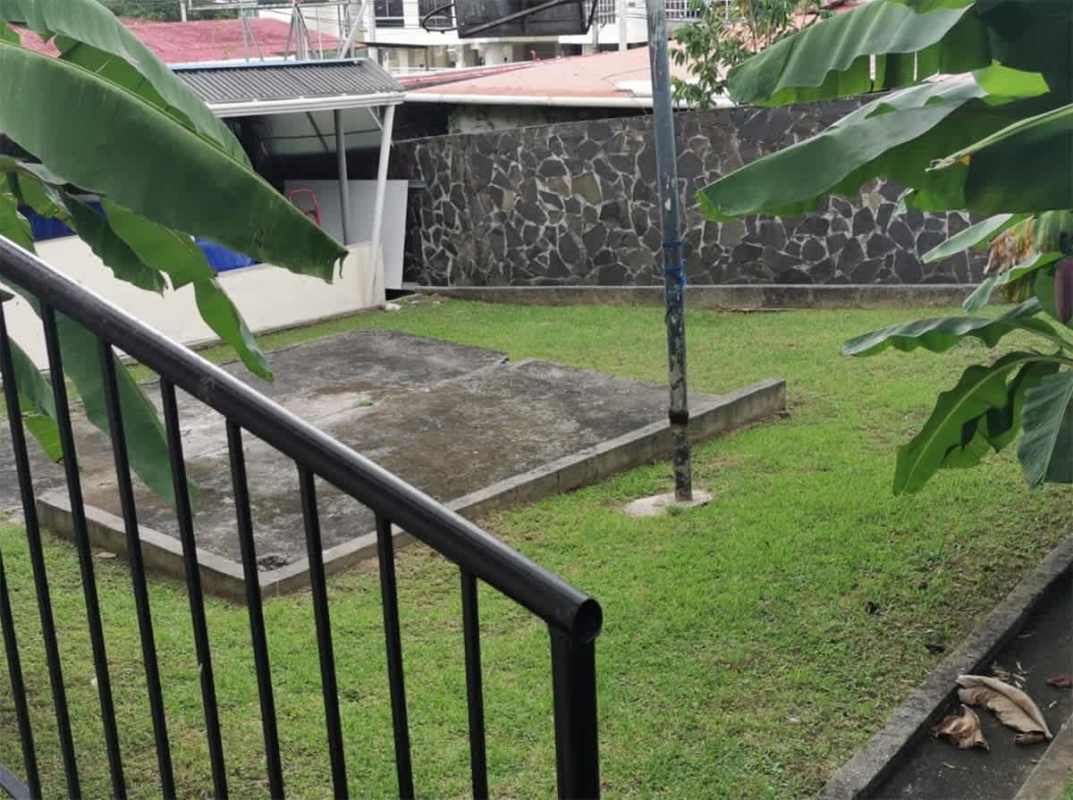 Spacious traditional living room with large windows and wooden furniture in Club X Bethania Panama