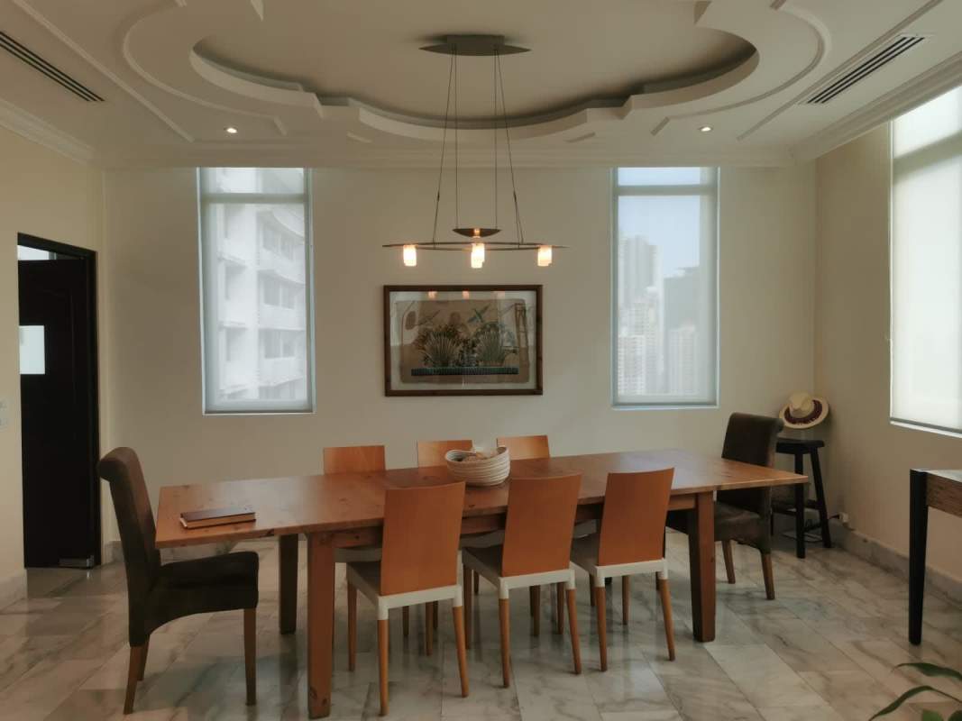 Bright elegant living and dining room with marble floors in PH Bahía Obarrio apartment Panama City