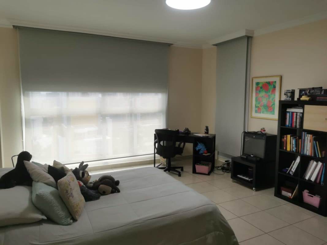 Open kitchen with granite countertops, wood cabinets, and appliances in PH Bahía Obarrio