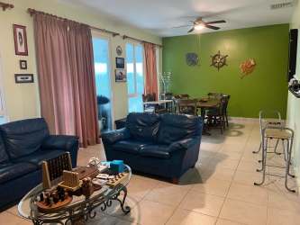 Open concept living dining room with tile floors, ceiling fan, garden views in Bijao Residences Rio Hato Panama