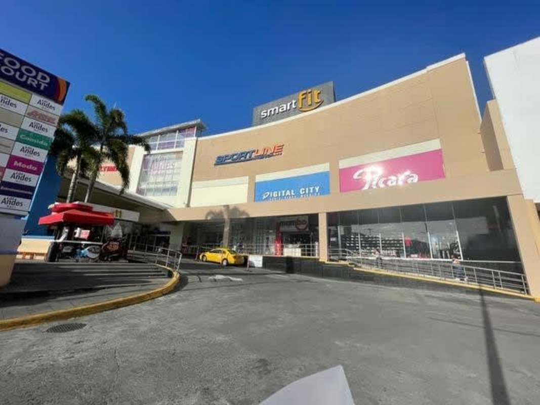 Interior view of multiple retail floors with kiosks shop windows escalators Los Andes Mall Panama