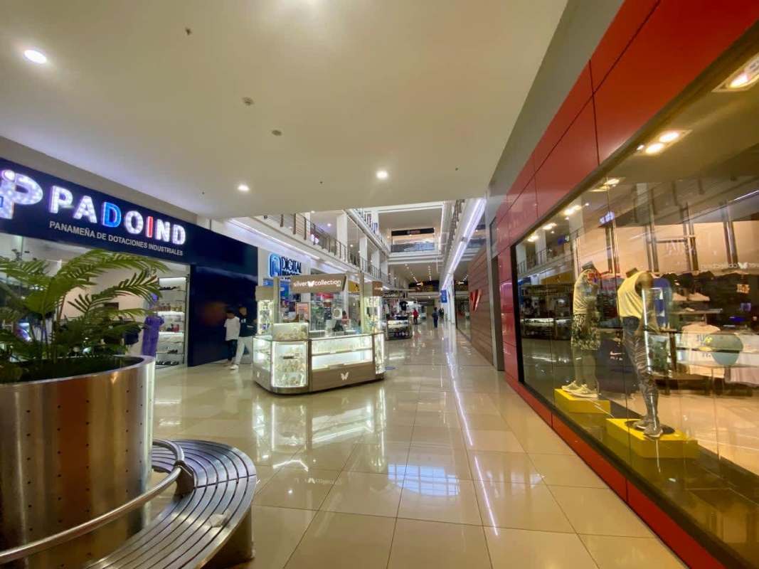 Multi-story interior atrium with escalators retail stores kiosks glass railings inside Los Andes Mall Panama