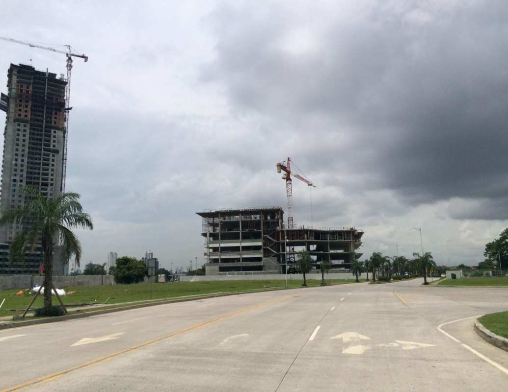 Commercial high-rise buildings under construction with cranes at business district Panama