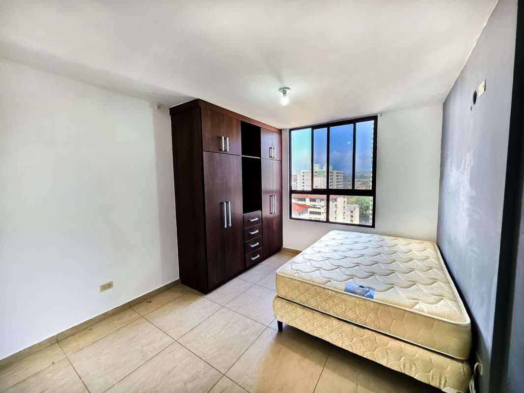 Minimalist bedroom with window city view and wardrobe PH Terrazas del Rey