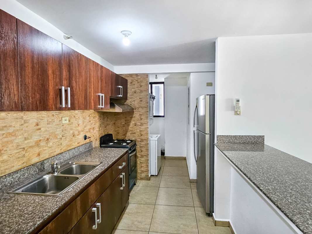 Kitchen with stacked laundry area in PH Terrazas del Rey Condado del Rey