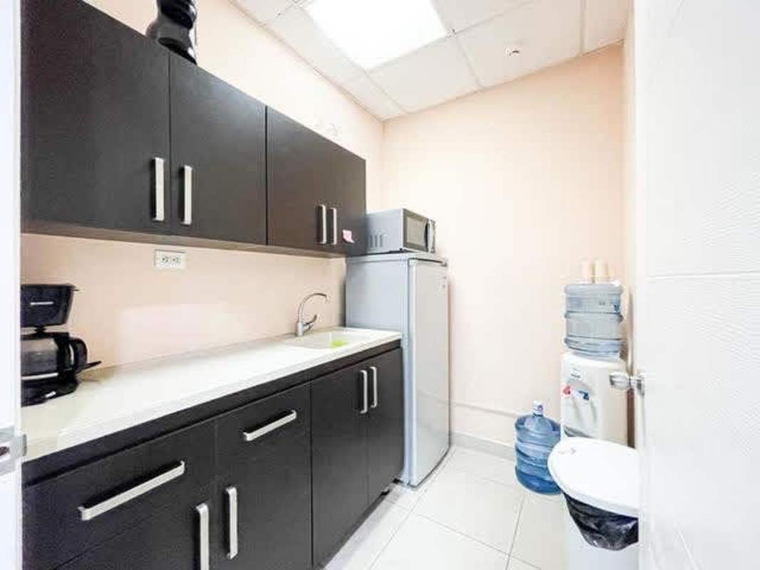 Compact kitchenette with modern appliances in PH Banesco Tower office Marbella