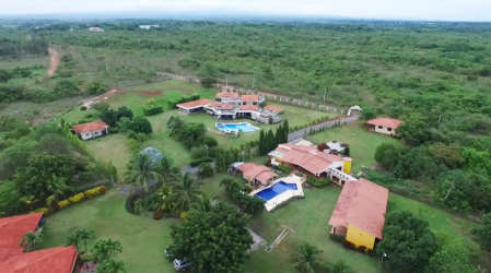 Covered patio with hammock lounge and gardens at luxury beach estate in Sea Cliff Panama