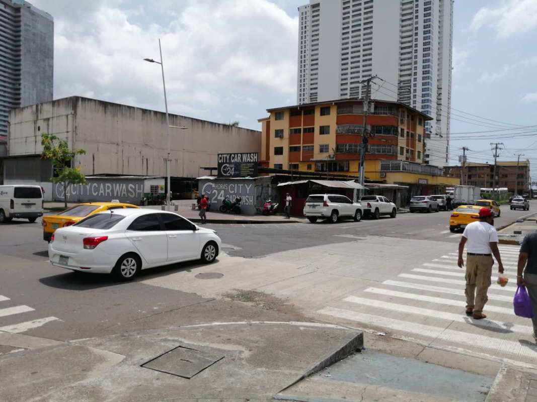 Empty urban lot at busy Panama City street next to apartment and office towers in Calidonia
