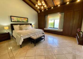 Covered patio terrace overlooking pool and lake in Buenaventura luxury villa Panama