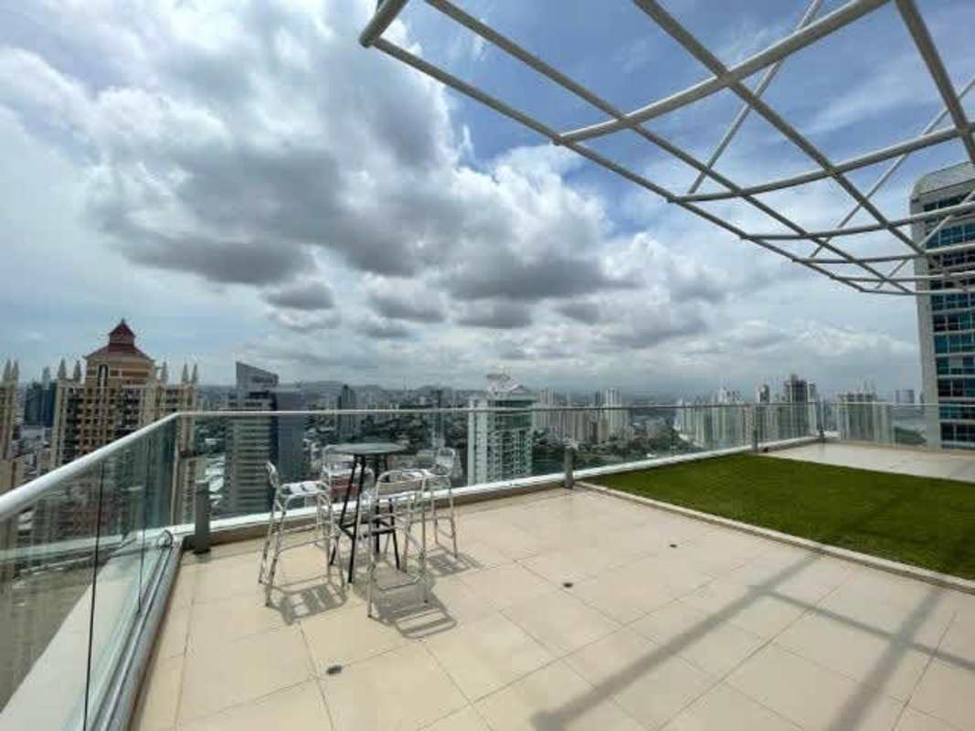 Spacious open-plan living room with spiral stairs, tall windows, city views in PH Loft Four 41 Punta Pacifica
