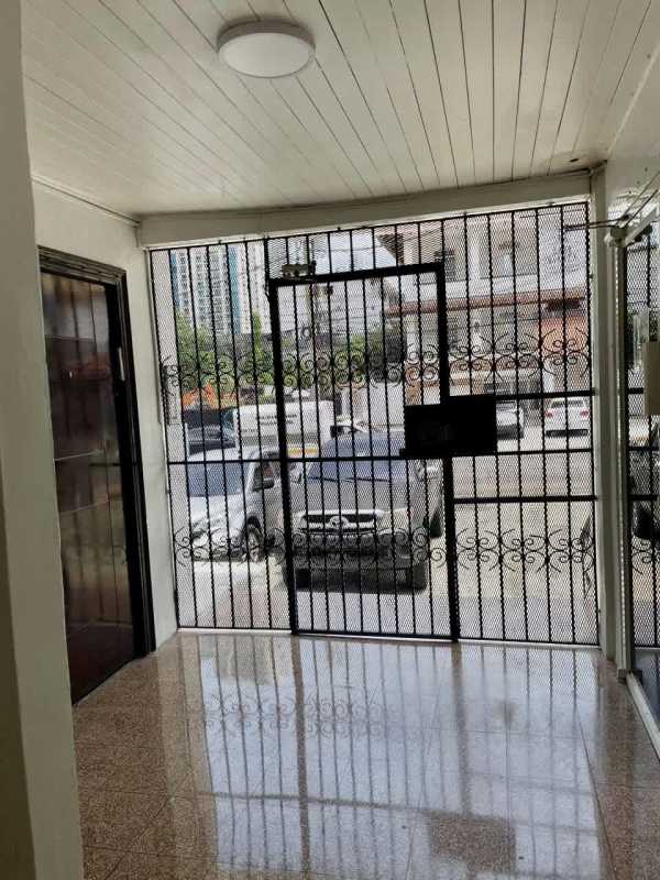 Entrance lobby with white tiled floor, metal decorative security gate, in Bella Vista Panama building