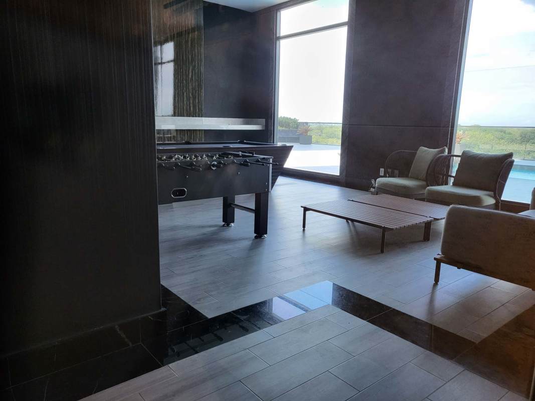 Modern kids playground with swings, rubber flooring in Empire Residences Santa María Panama