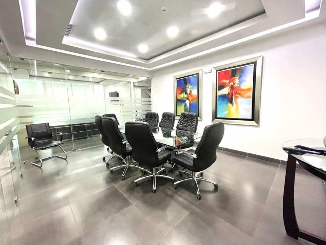 Modern conference room with black chairs, glass partition walls in PH Office One Obarrio