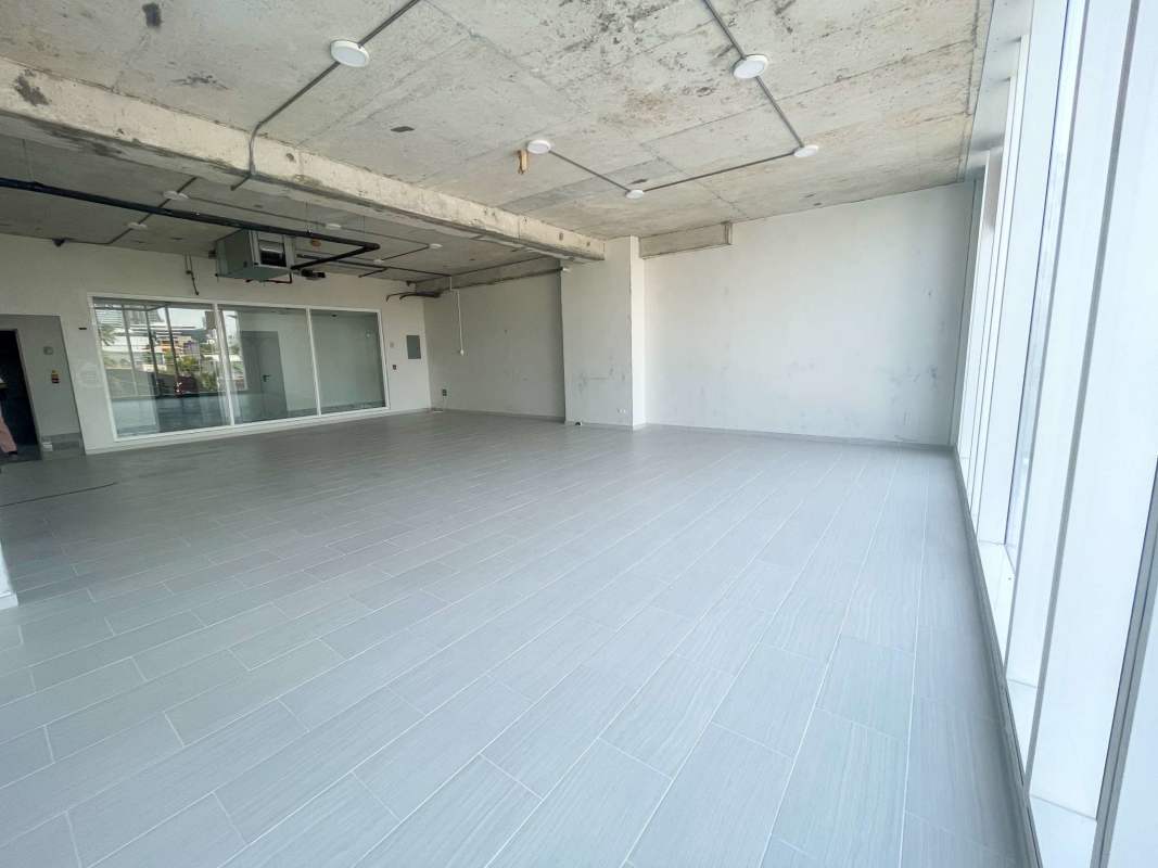 Empty commercial office space with large windows exposed ceiling in PH Tower Business Plaza San Francisco Panama