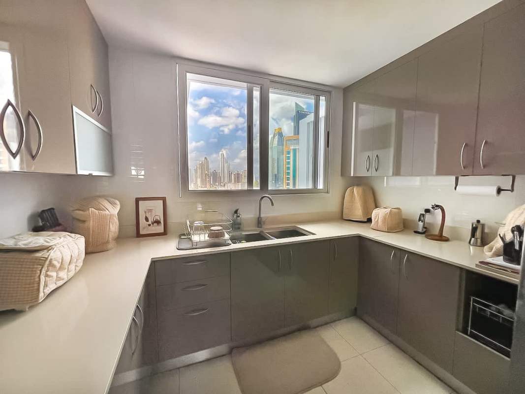 Renovated kitchen with granite counters and stainless steel appliances PH Marbella Tower II Panama City