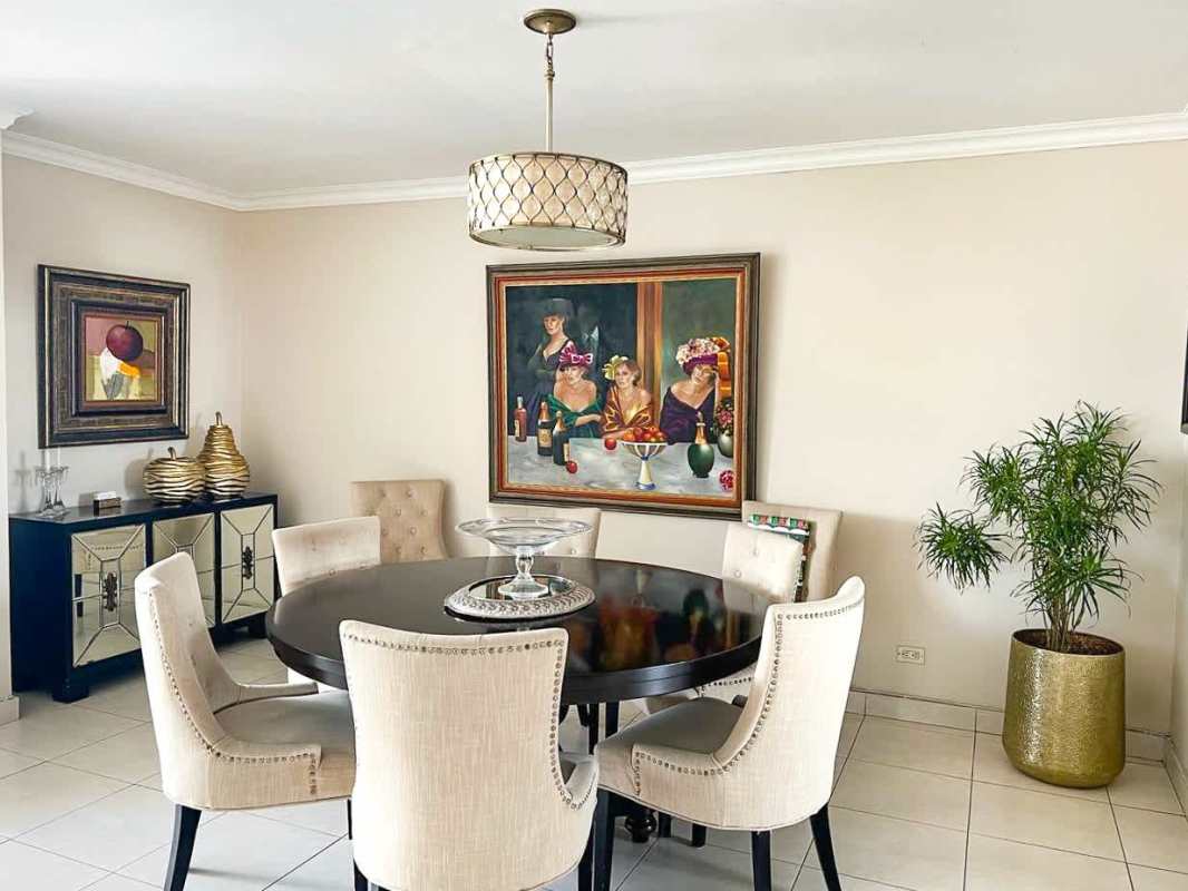 Elegant dining area with statement art and beige chairs PH Marbella Tower II Panama City