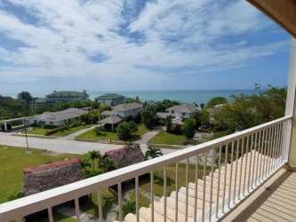 Stunning view of Bijao Beach Club, pool, and Pacific Ocean from condo balcony at Cocoli Tower Panama