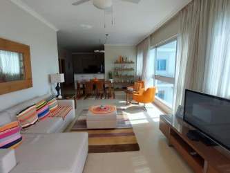 Open living dining room with sectional sofa, TV, large windows at Cocoli Tower Bijao Panama