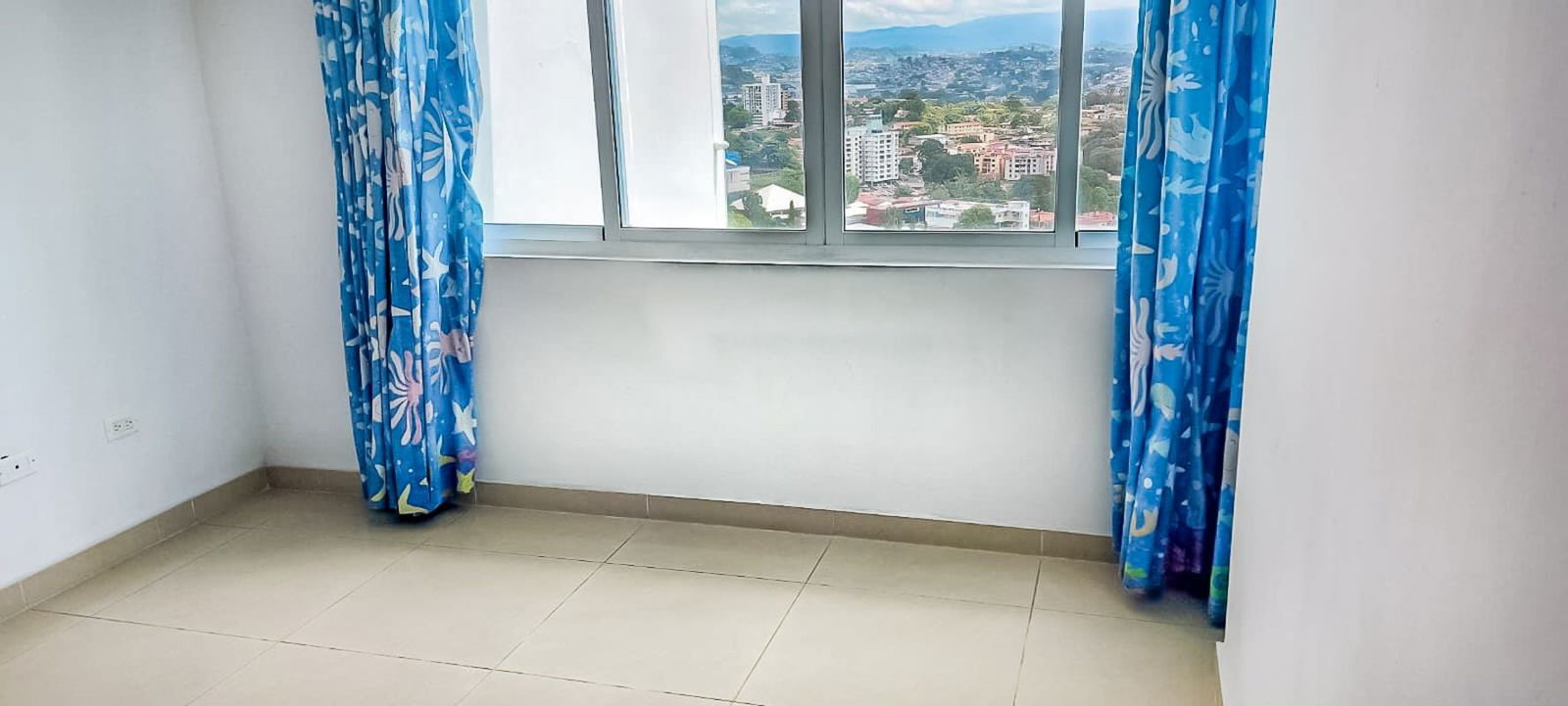 Bedroom with large window skyline view in PH Park Lane Panama apartment for sale