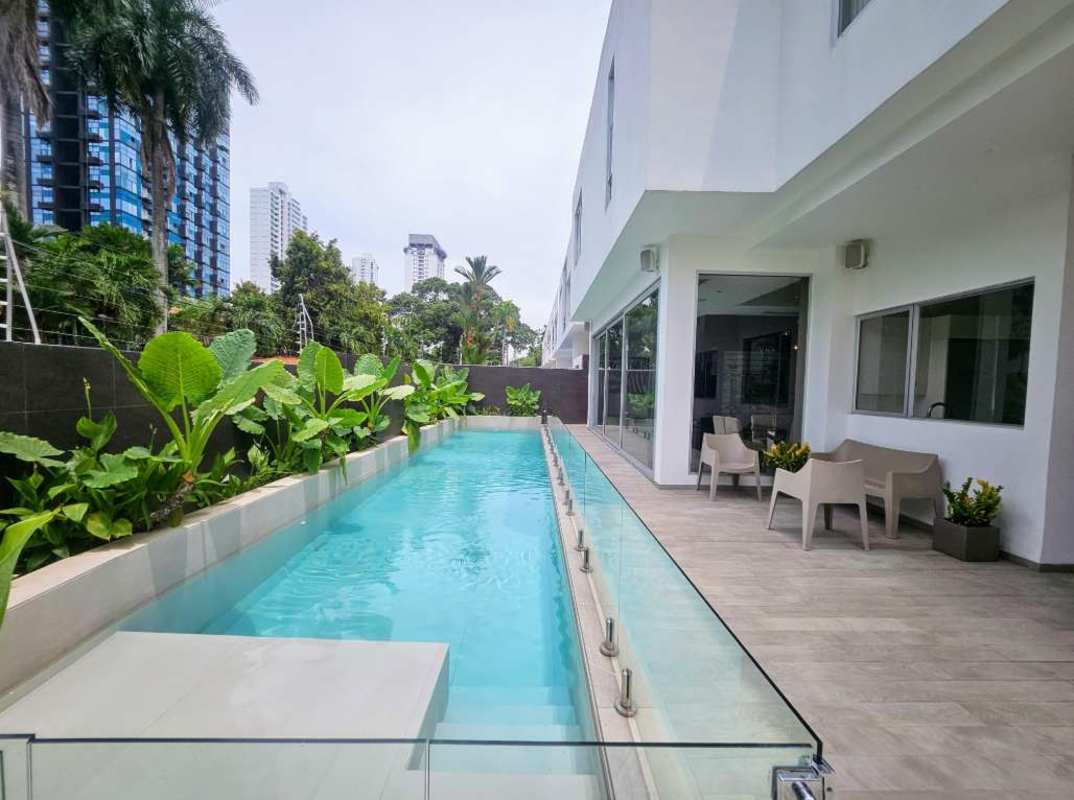 Spacious private gym with floor-to-ceiling windows overlooking greenery in Altos del Golf Panama