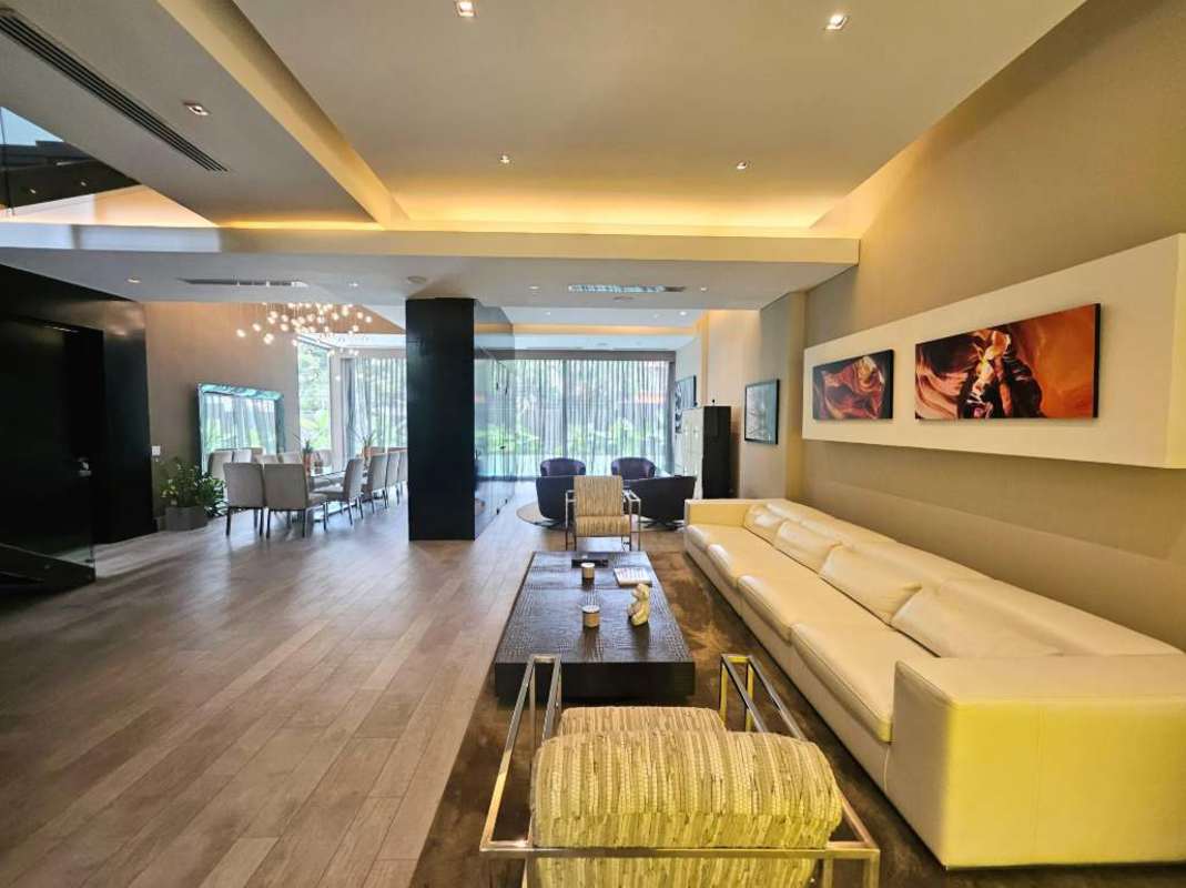 Narrow private pool with glass safety barrier and outdoor lounge Altos del Golf Panama