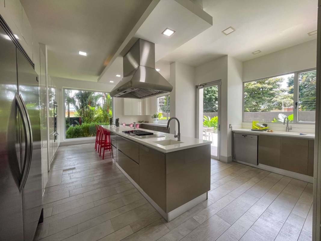 Formal dining room with glass wine storage and chandelier luxury house Altos del Golf Panama