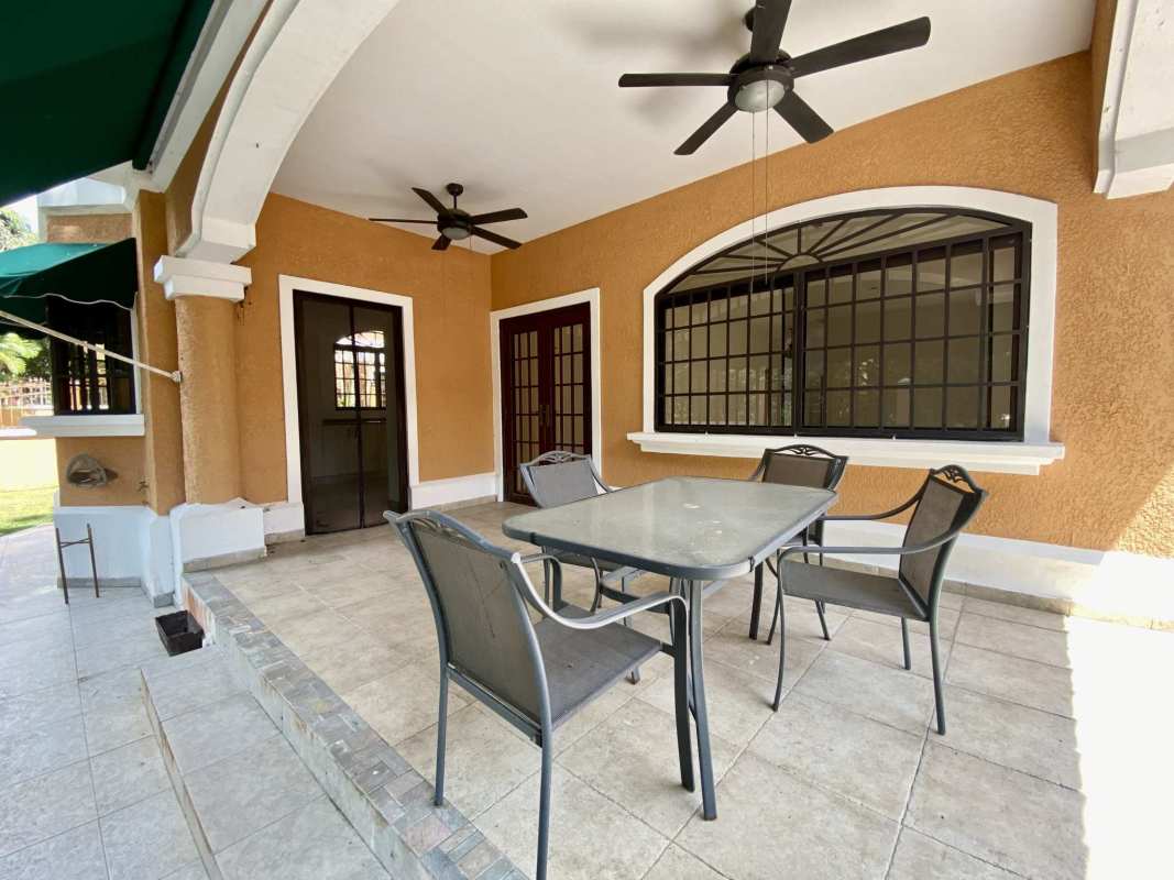 Covered patio ceiling fans iron details tile floor arched openings Clayton Panama