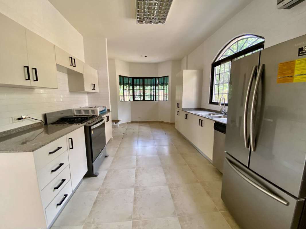 Bright kitchen granite countertops large windows stainless appliances Clayton Panama