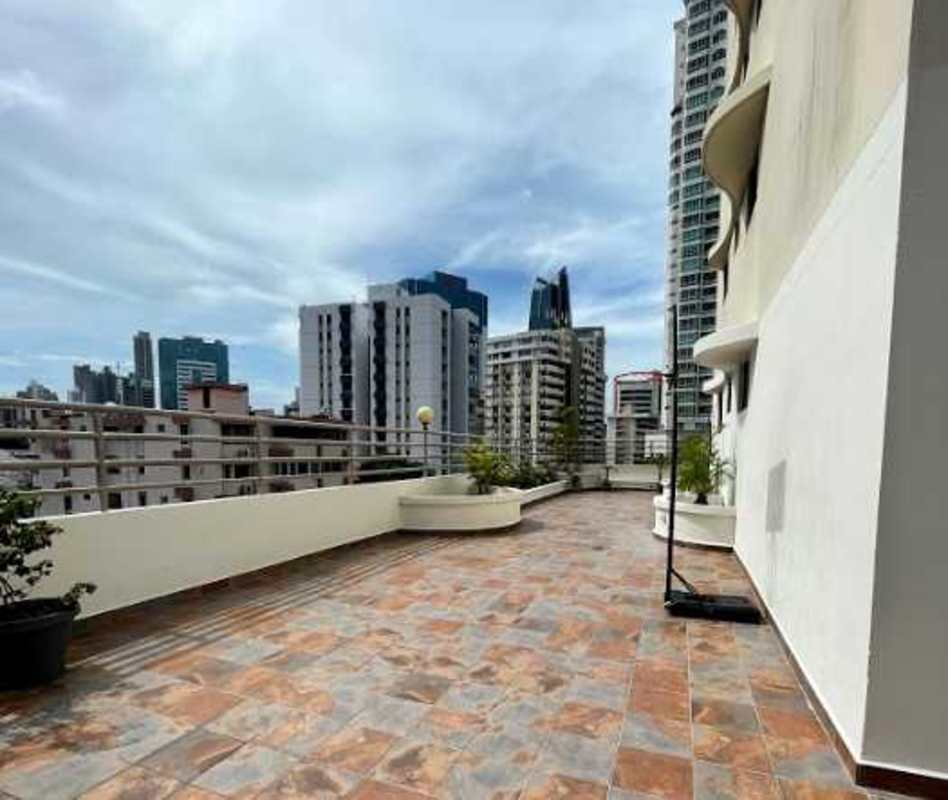Modern kitchen with unique stone finish walls, wood cabinetry, PH Torre Marbella