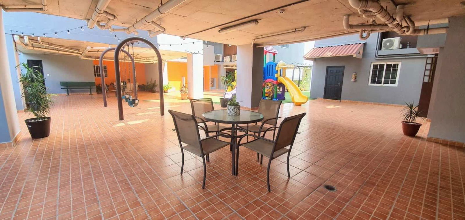 Covered children's playground with slide swings and seating PH Madison Towers Condado del Rey Panama