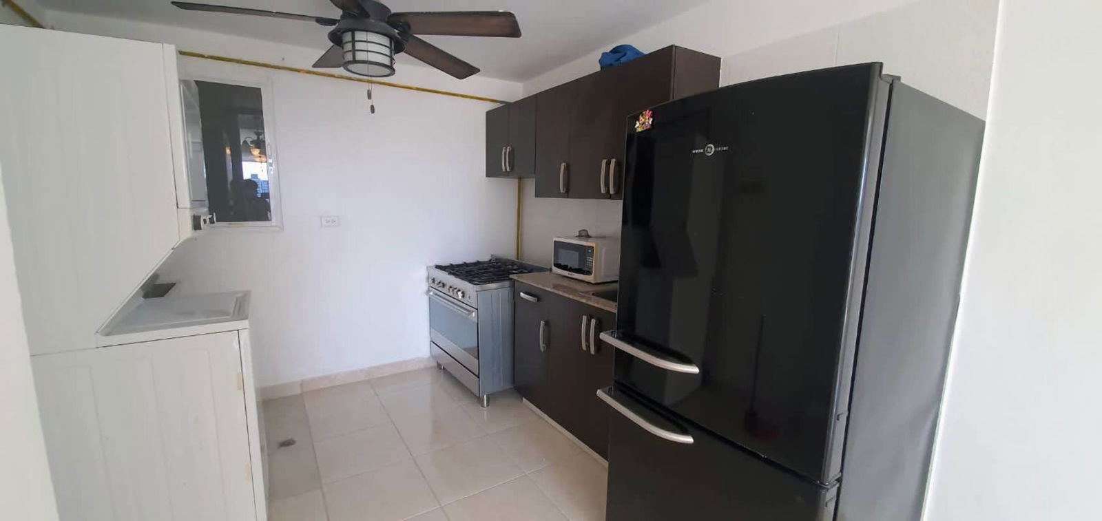 Kitchen with granite countertops, tile flooring, and ceiling fan in PH Madison Towers Panama
