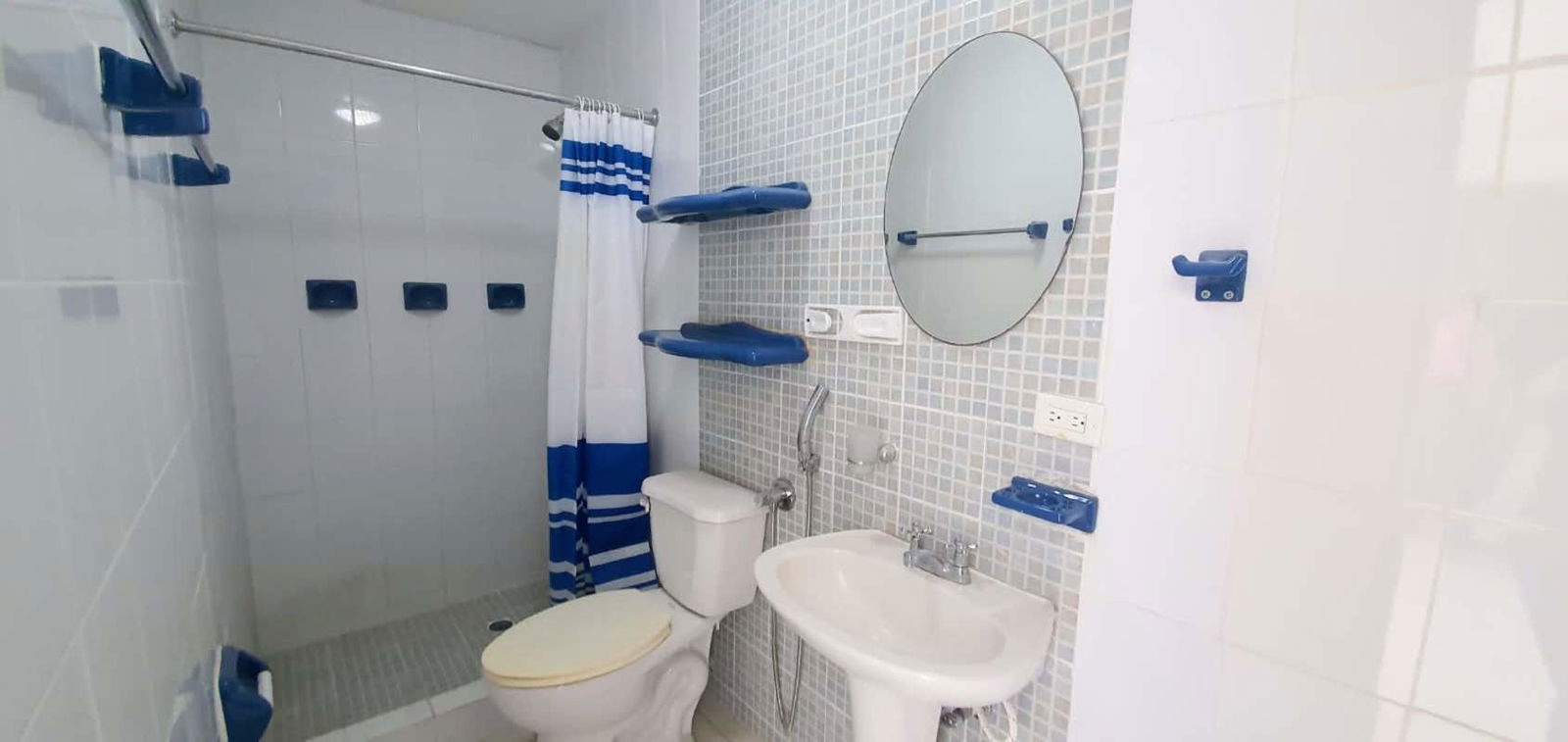 Bathroom with walk-in shower mosaic accent wall white ceramics PH Madison Towers Condado del Rey