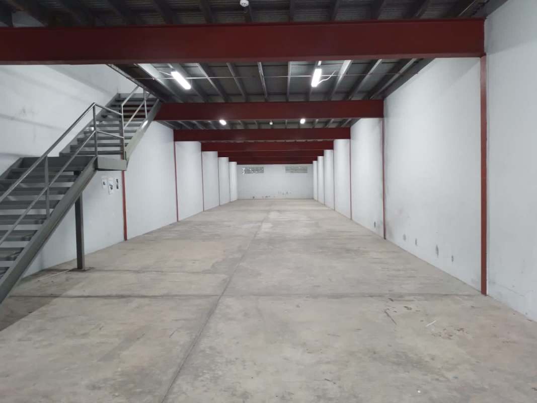 Empty warehouse interior with metal beams, high ceiling and concrete floor Balzac Park Juan Díaz Panama