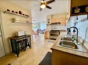 Bright master bedroom with ceiling fan and balcony access overlooking ocean in Farallón Panama