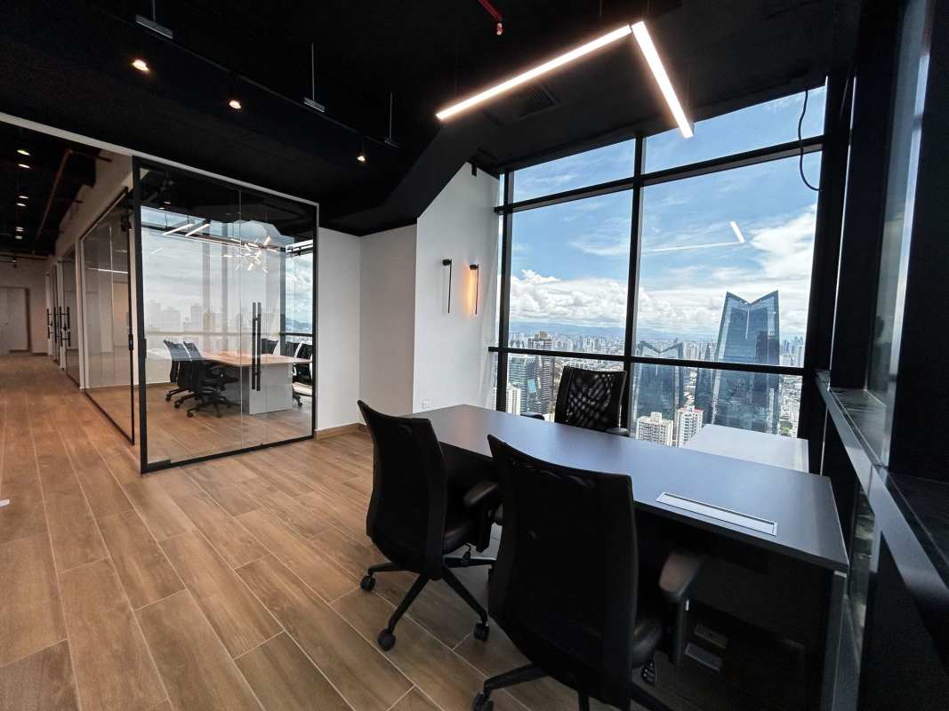 Open modern office with glass partitions and panoramic views in Tower Financial Center Panama