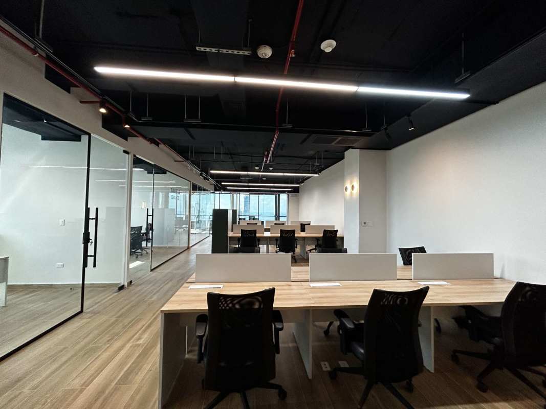 Modern open workspace with desks in Tower Financial Center Panama City skyline view