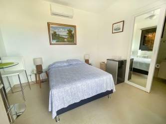 Bright master bedroom with large window at Hacienda Pacífica house San Carlos
