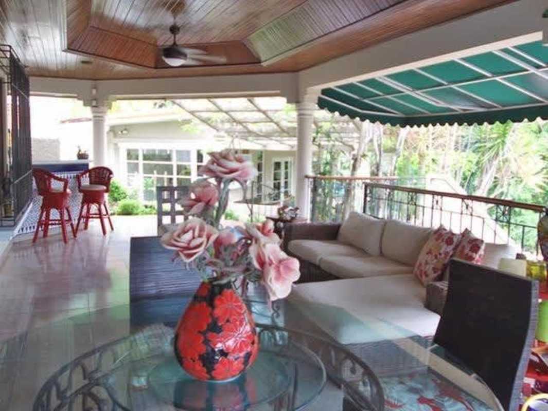 Spacious master bedroom with elegant decor, large windows, balcony in Dos Mares Panama house