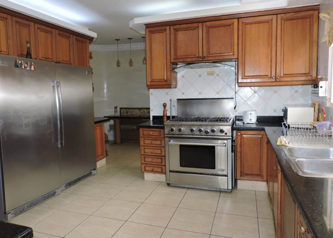 Spacious island kitchen granite counters wood cabinets appliances Costa Dorada Costa del Este Panama