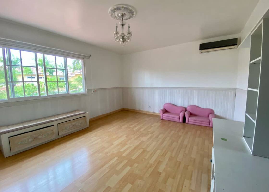 Bright living room with tile floors chandeliers large windows overlooking garden Costa Dorada Panama
