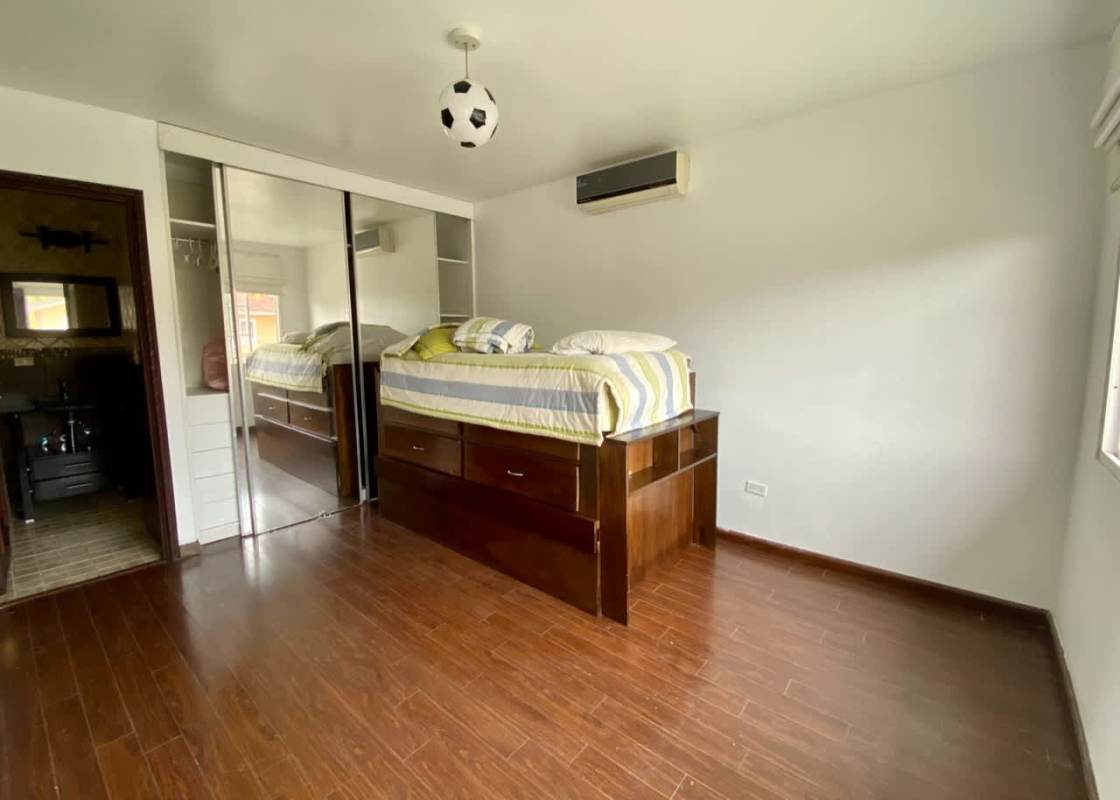 Elegant staircase with wrought iron railings and chandelier in luxury home Costa del Este