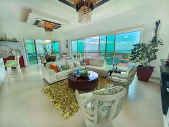 Bright contemporary living room with large windows and ocean view at Punta Barco Village Panama