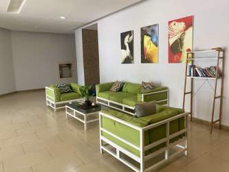 Beachfront saltwater lagoon pool surrounded by palm trees seen from apartment balcony in PH Founders Playa Blanca Panama