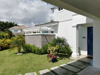 Spacious covered terrace with outdoor dining area and kitchen overlook pool Bijao Beach Residences Panama