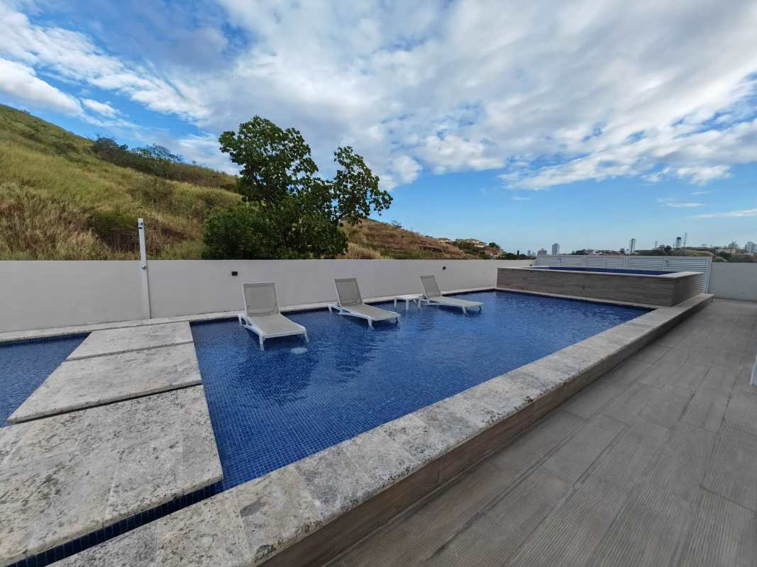 Bedroom with large mirrored closet doors, city view window, tile flooring in PH Country Heights Condado del Rey Panama
