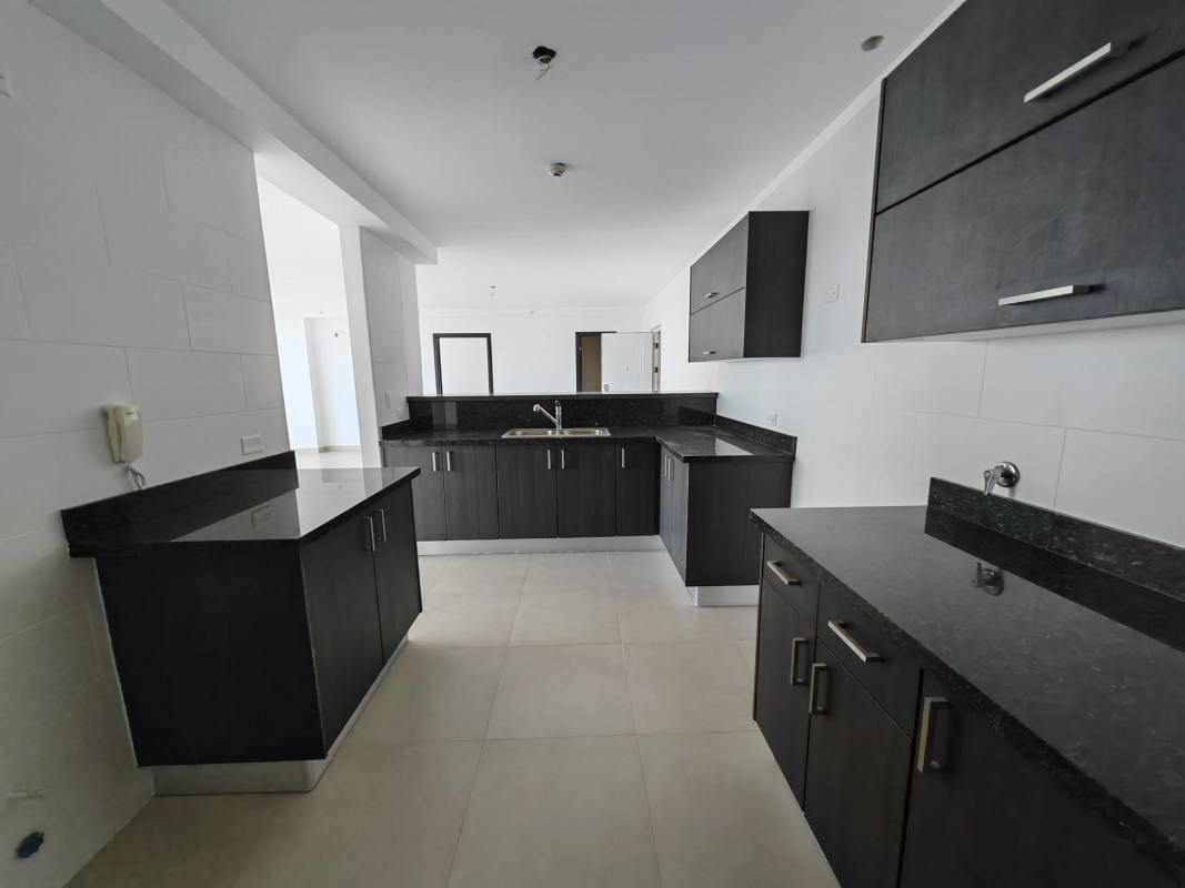 Children’s colorful outdoor playground with slide and swing next to pool area in PH Country Heights Panama