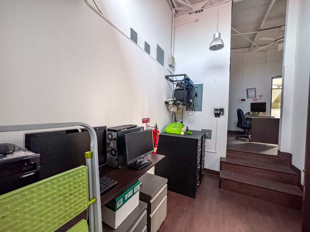 Compact kitchenette with white cabinets and high ceiling in commercial property San Francisco Panama