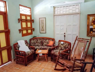 Traditional living room with wood furniture and lush colonial style in Panama house