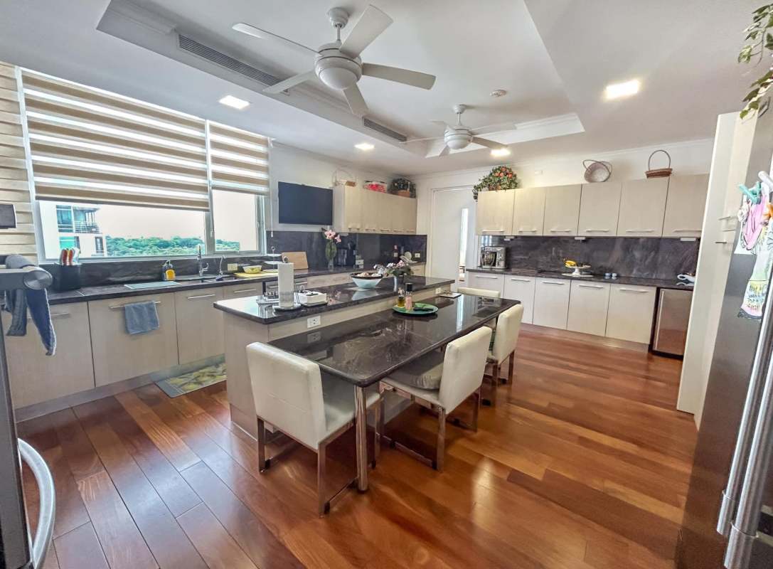 Modern gourmet kitchen with granite island and stainless appliances in PH Santorini Coco del Mar