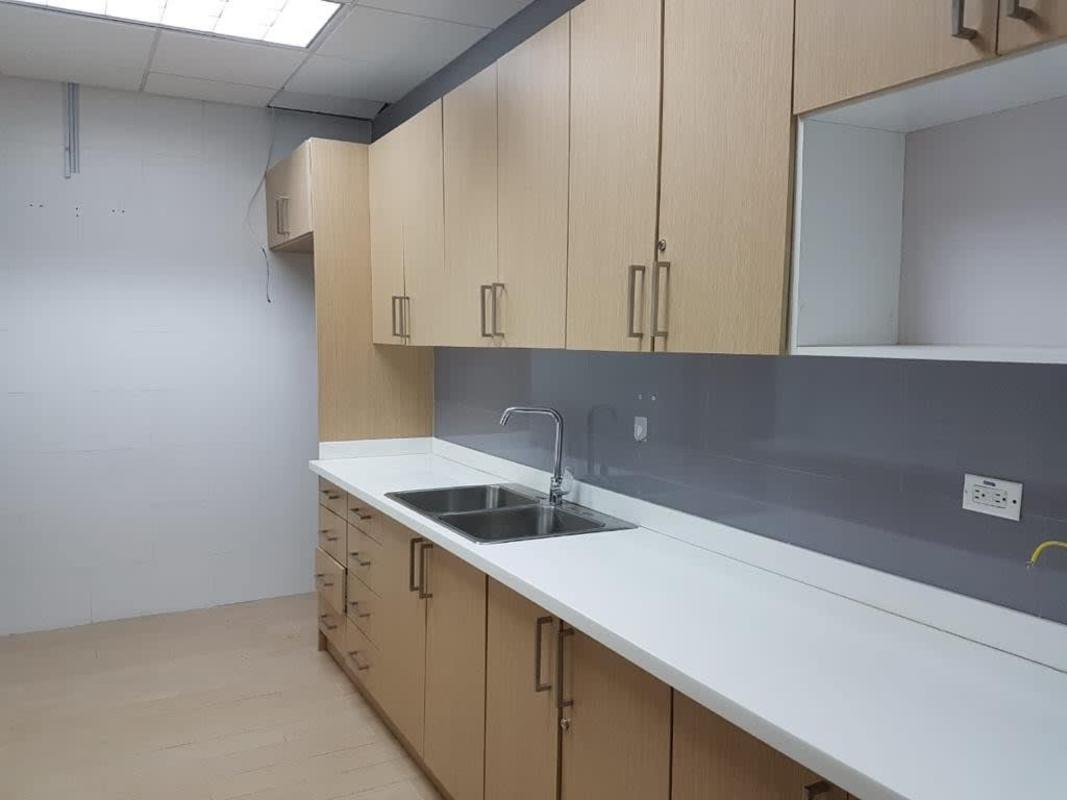 Glass-wall hallway recessed lighting Torre Mapfre premium office Panama